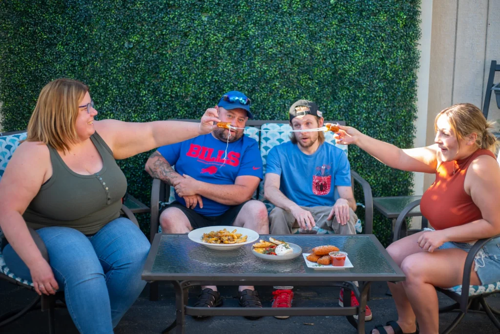 Friends enjoying a community gathering on the Lodge patio